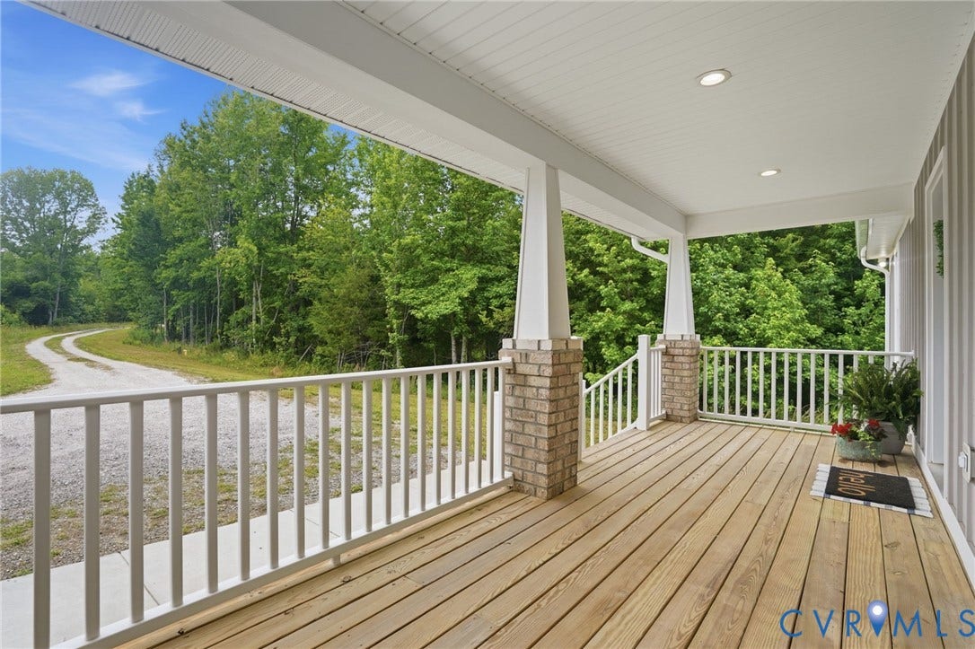 2677 Dogtown Road, Goochland, VA 23063 Expansive front porch featuring natural wood decking, white balusters, and brick-clad columns