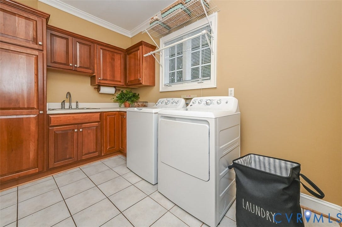 10809 Leabrook Drive, Wyndham, Glen Allen, VA 23059 First floor Laundry Room with washer and dryer, utility sink, Cherry cabinets and tile floor. Door access to the garage