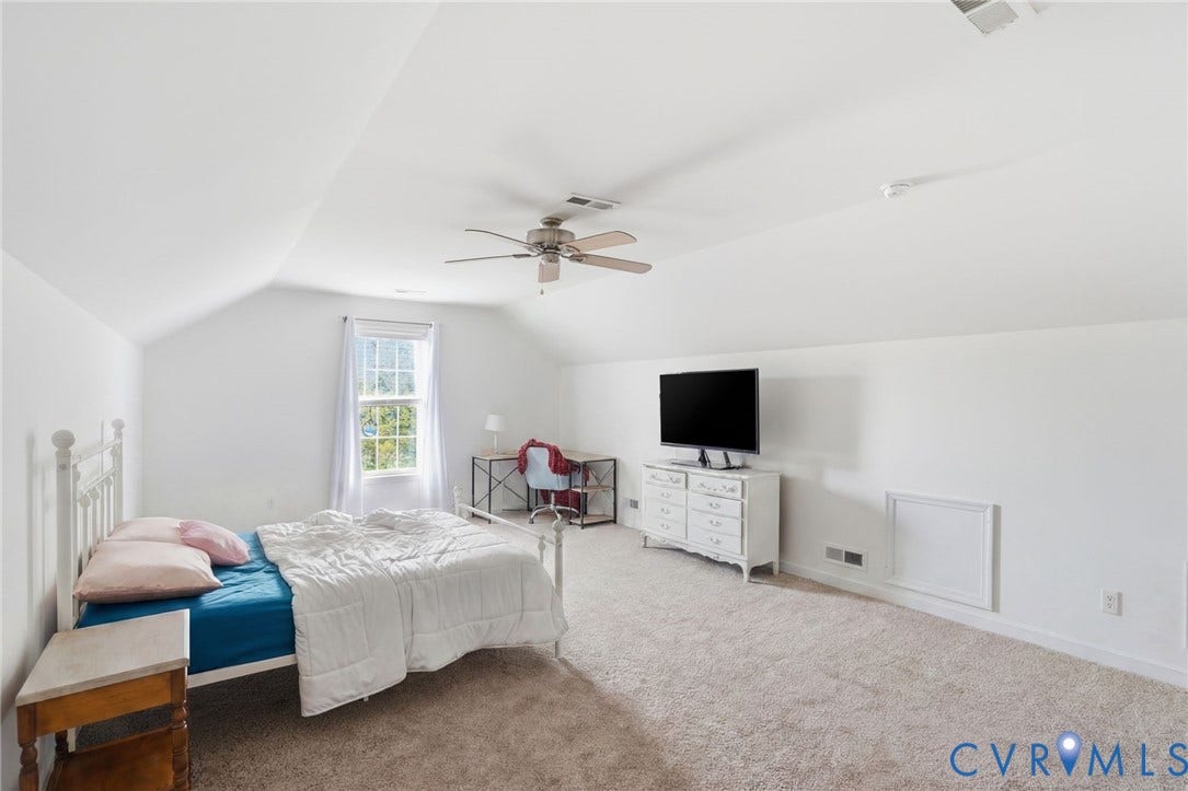 5305 Wellington Ridge Road, Richmond, VA 23231 Spacious room featuring vaulted ceilings, a ceiling fan, a window with natural light, and carpeting