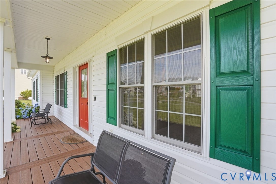 5305 Wellington Ridge Road, Richmond, VA 23231 Inviting front porch featuring wood-finish decking, white siding, and a red entry door
