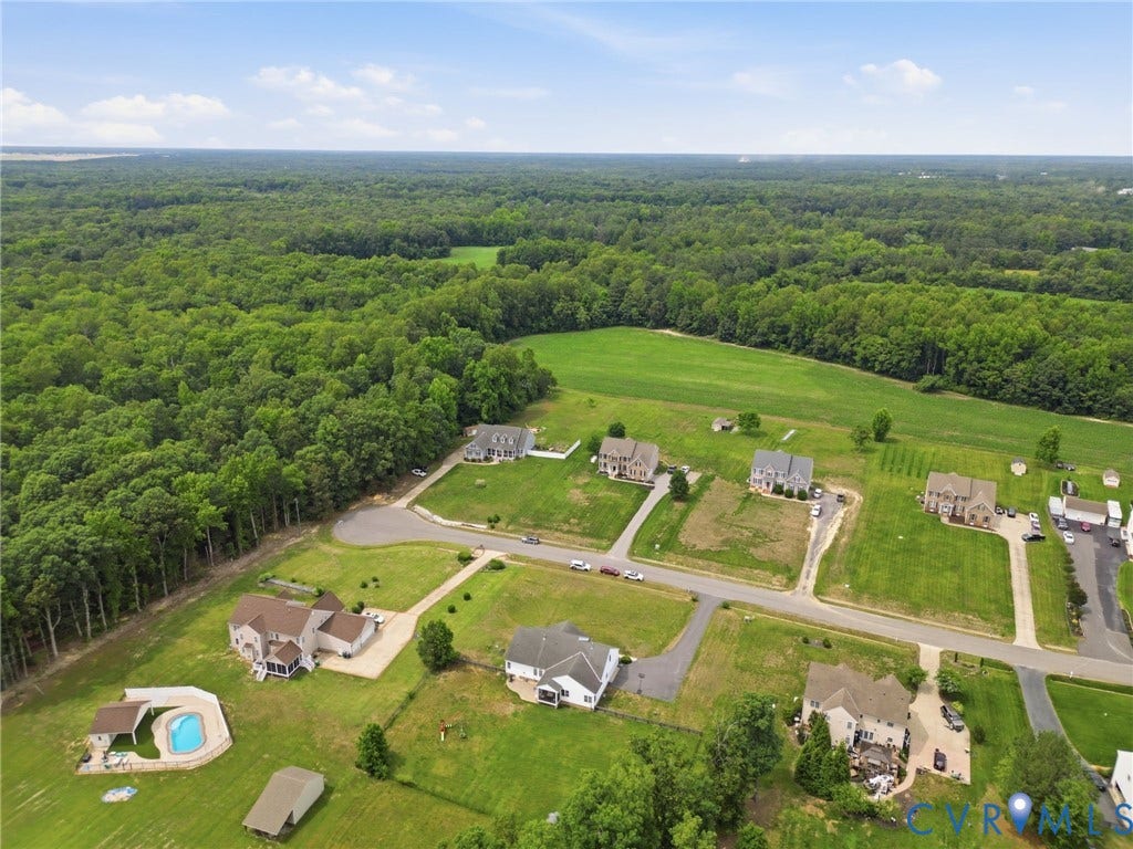 5305 Wellington Ridge Road, Richmond, VA 23231 Aerial perspective showcasing a residential community surrounded by expansive wooded areas and open fields