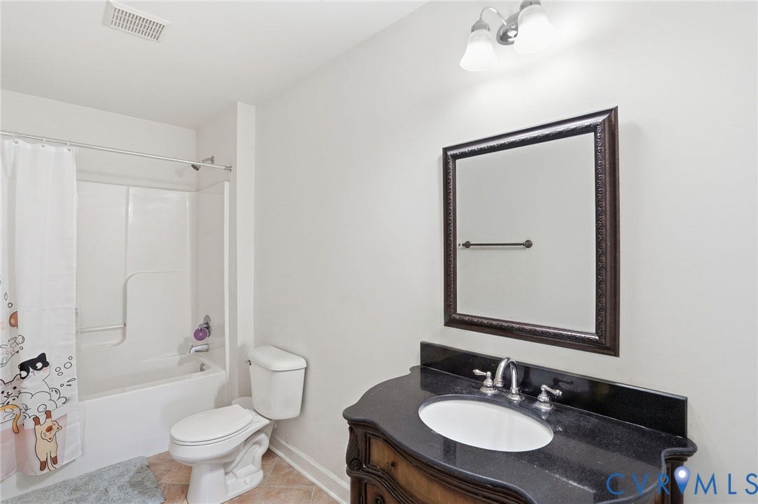 5305 Wellington Ridge Road, Richmond, VA 23231 Bathroom with a dark wood vanity, integrated sink, and granite-style countertop