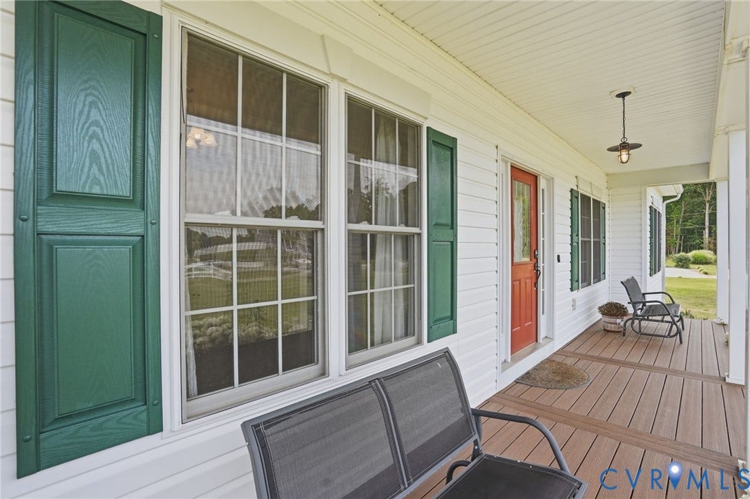 5305 Wellington Ridge Road, Richmond, VA 23231 Expansive covered front porch featuring wood-finish composite decking, white siding, and green paneled shutters