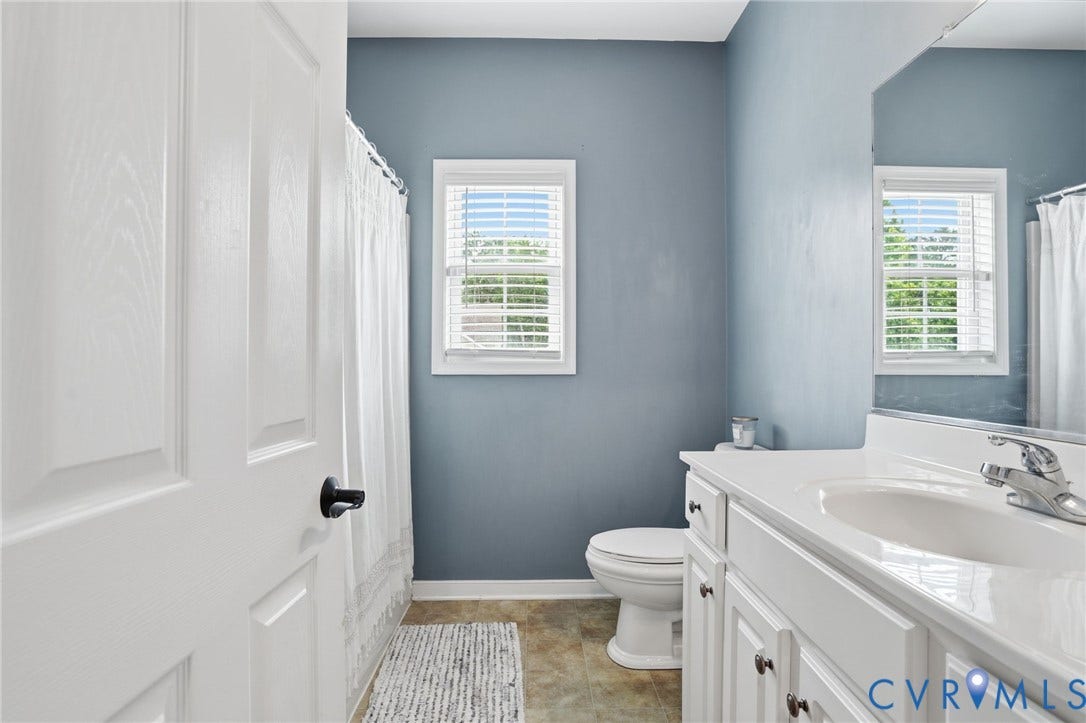 5305 Wellington Ridge Road, Richmond, VA 23231 Bathroom featuring a white vanity with an integrated sink, chrome faucet, and storage cabinetry