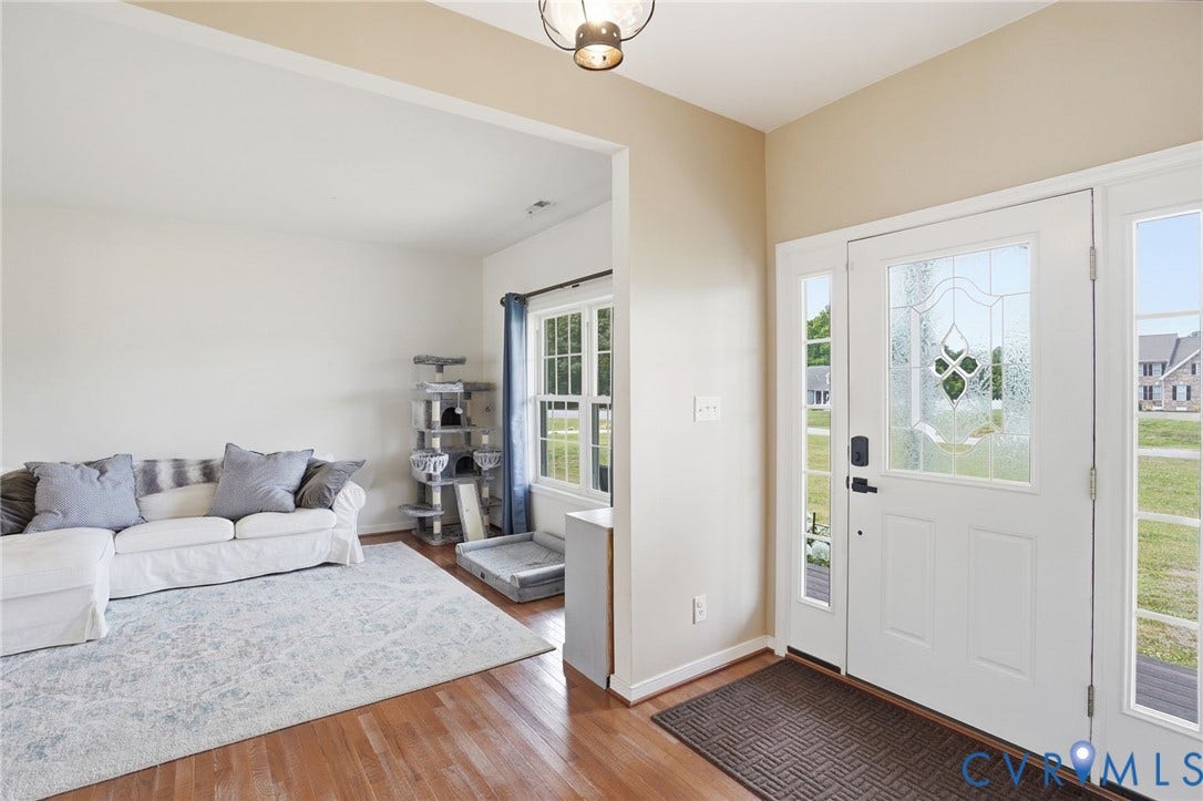 5305 Wellington Ridge Road, Richmond, VA 23231 Entryway featuring a white door with decorative glass, sidelight windows, and rich wood-finish flooring