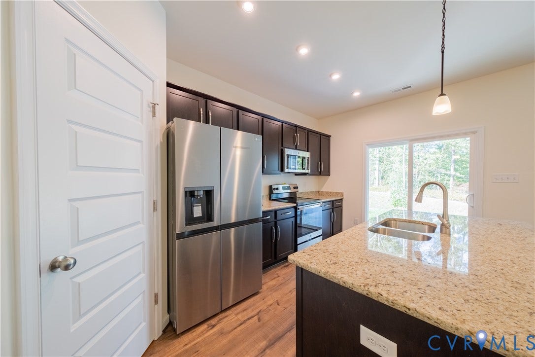 18372 Palisades Court, Chesterfield, VA 23120 Kitchen featuring dark wood cabinetry, light granite countertops, stainless steel appliances, and wood-finish flooring