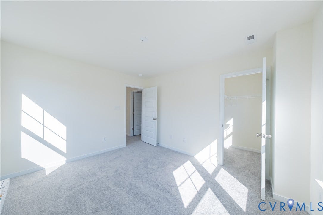 18372 Palisades Court, Chesterfield, VA 23120 Neutral-toned room featuring light gray carpeting, white walls, and white trim
