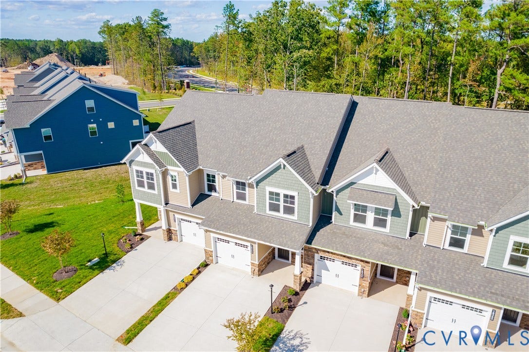 18372 Palisades Court, Chesterfield, VA 23120 Row of newly constructed townhomes featuring multi-toned siding, attached garages, and a paved driveway