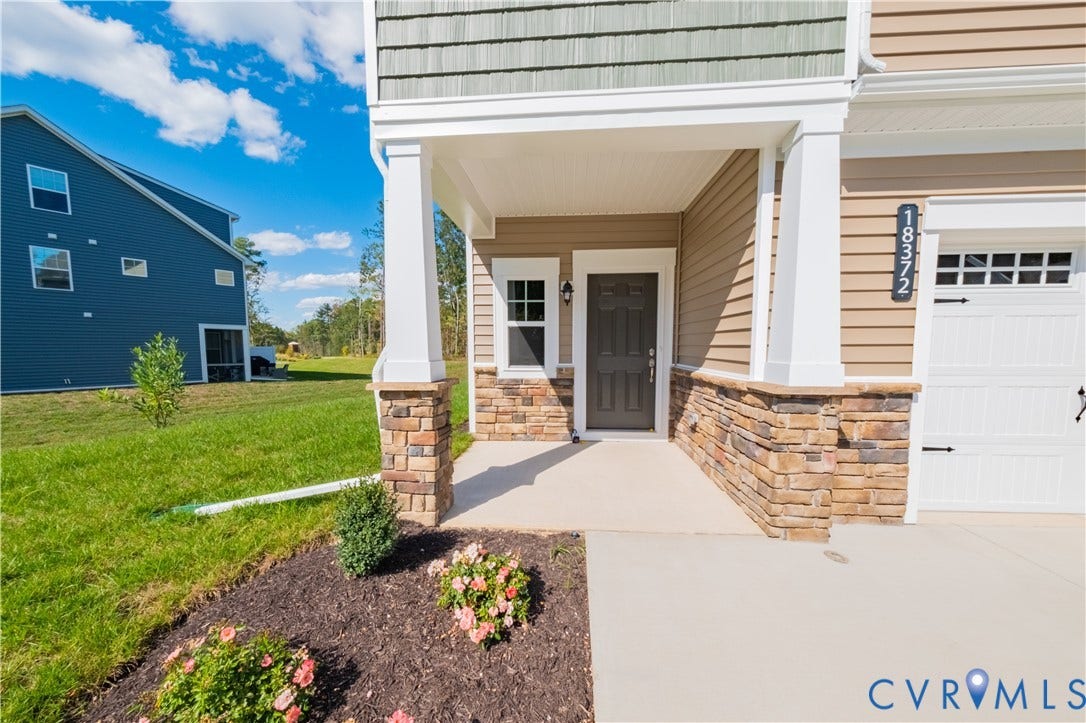 18372 Palisades Court, Chesterfield, VA 23120 Stone veneer column bases complement the covered entryway and light brown siding