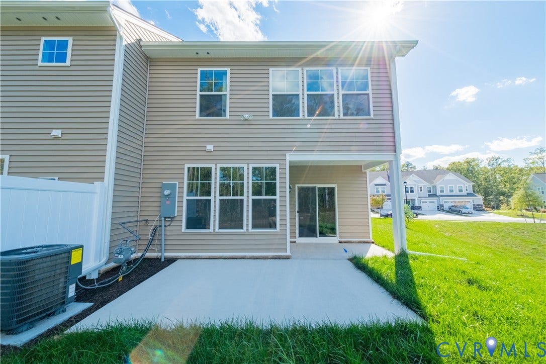 18372 Palisades Court, Chesterfield, VA 23120 Rear exterior featuring neutral tone siding, a concrete patio, and a sliding glass door