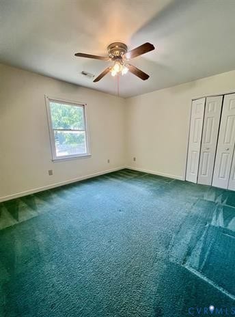 Carpeted interior space featuring a window, ceiling fan with integrated lighting, and bi-fold closet doors