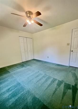 Room featuring vibrant green carpeting, light-toned walls, and a ceiling fan with integrated lighting