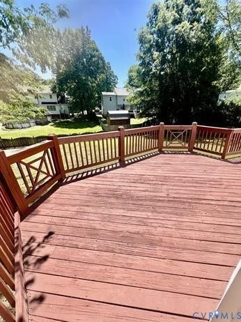 Expansive outdoor decking featuring a red-stained finish and full wood railing