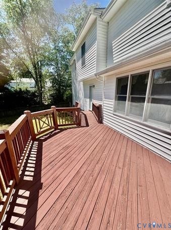 Expansive wood deck with rich red-brown stain and matching railings