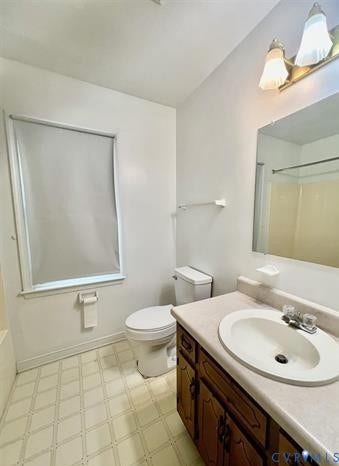 Bathroom featuring a single window with roller shade, tile flooring, and a vanity with wood-finish cabinetry, a single basin sink, and a framed mirror