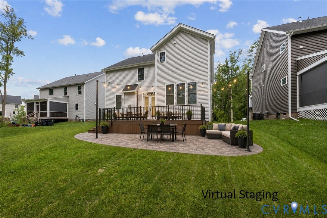 7125 Jones Run Lane, Glen Abby, Moseley, VA 23120 Backyard featuring a virtually staged paver patio, a wood-finish deck with black railings, and a manicured lawn