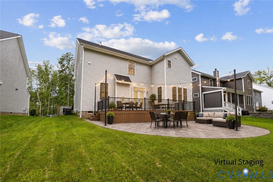 7125 Jones Run Lane, Glen Abby, Moseley, VA 23120 Backyard featuring a virtually staged composite deck with black metal railings, a large circular paver patio, and a sloped lawn