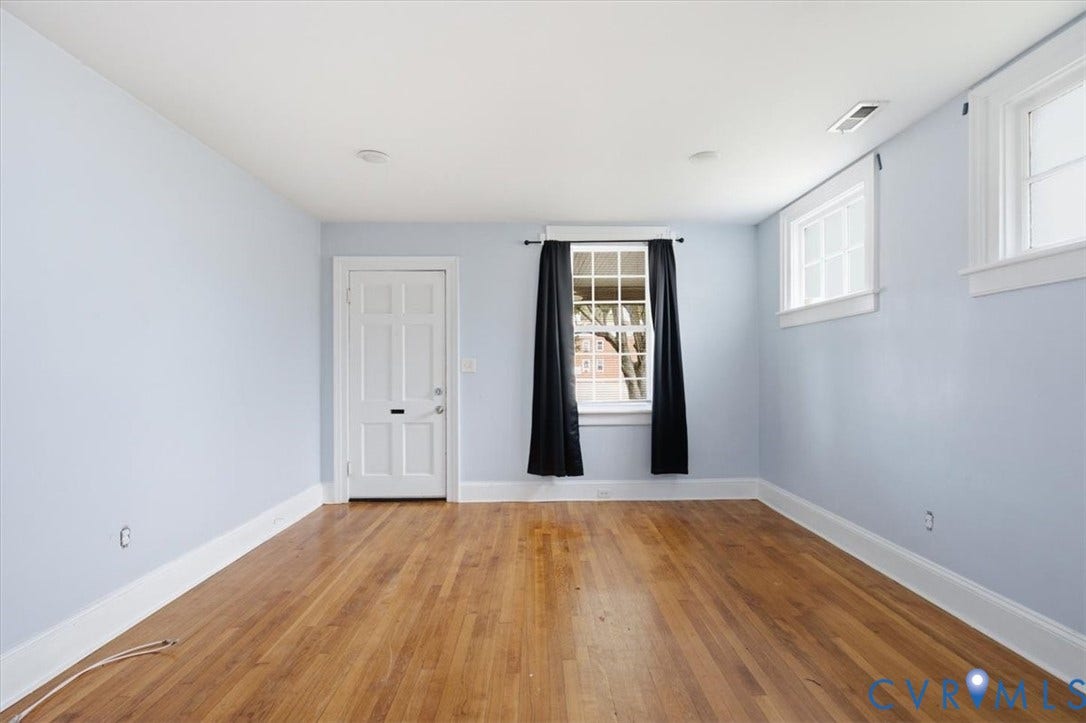 125 Richmond Avenue, Colonial Heights, VA 23834 Spacious room featuring wood-finish flooring, light blue walls, and white trim