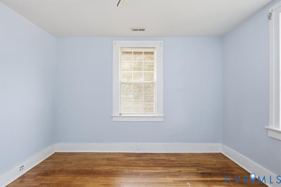125 Richmond Avenue, Colonial Heights, VA 23834 Light-filled room featuring wood-finish flooring, white baseboards, and a window with blinds