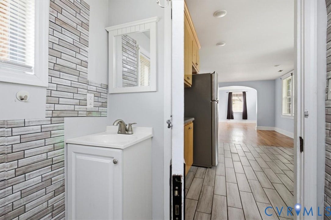 125 Richmond Avenue, Colonial Heights, VA 23834 Powder room featuring a single vanity with a white countertop and a framed mirror