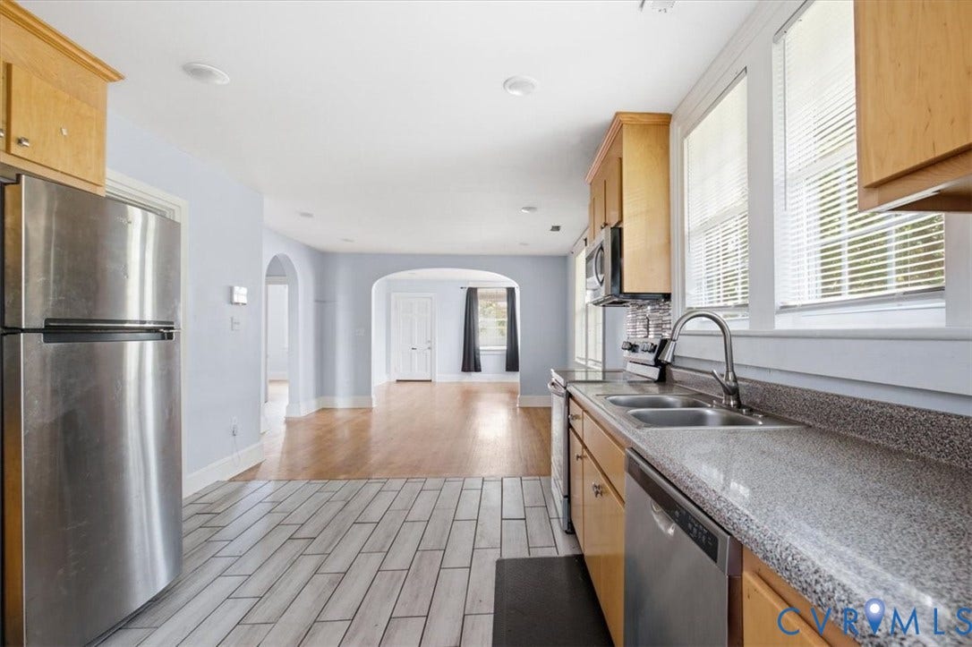 125 Richmond Avenue, Colonial Heights, VA 23834 Kitchen featuring wood-finish cabinetry, stainless steel appliances, speckled countertops, a dual basin sink, and a tiled floor