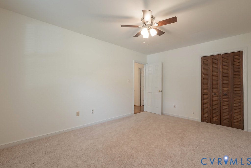 Neutral-toned carpeted flooring complements light walls