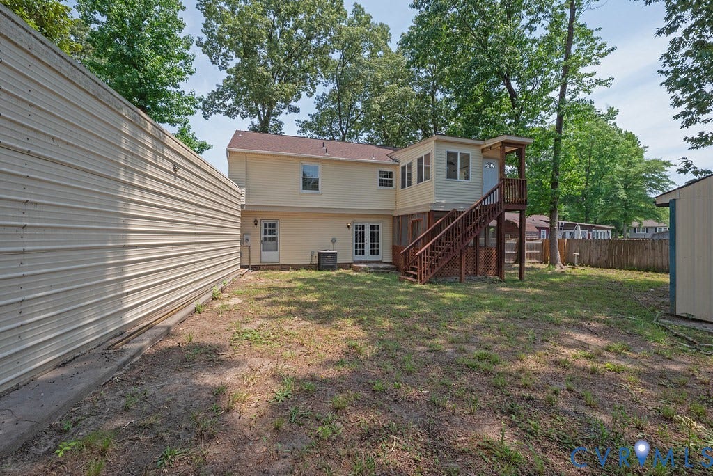 Two-story residence featuring a second-level sunroom with exterior access staircase