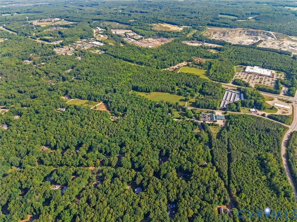 Expansive aerial perspective showcasing a vast wooded landscape with scattered residential properties