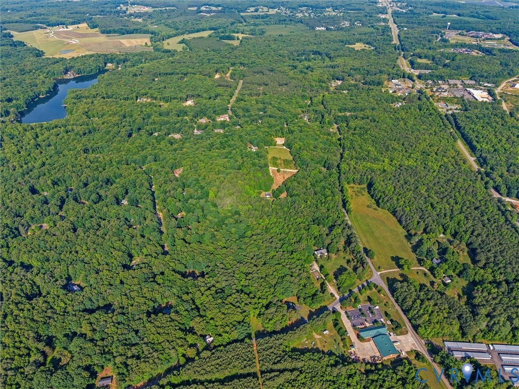 Expansive aerial showcasing a significant wooded parcel