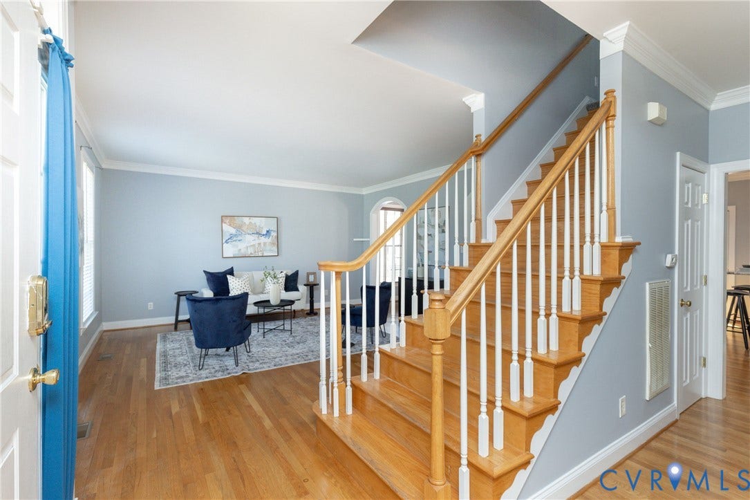 Hardwood flooring extending throughout the entry and main living area
