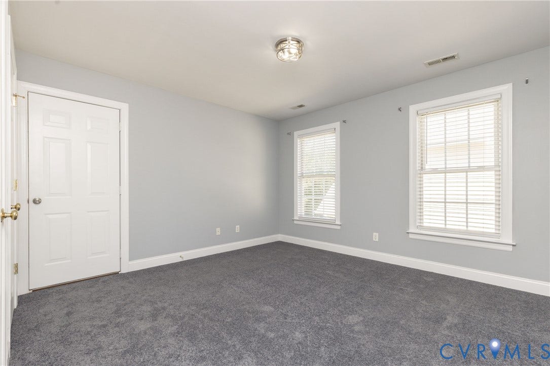 Neutral gray walls complement the gray carpeting