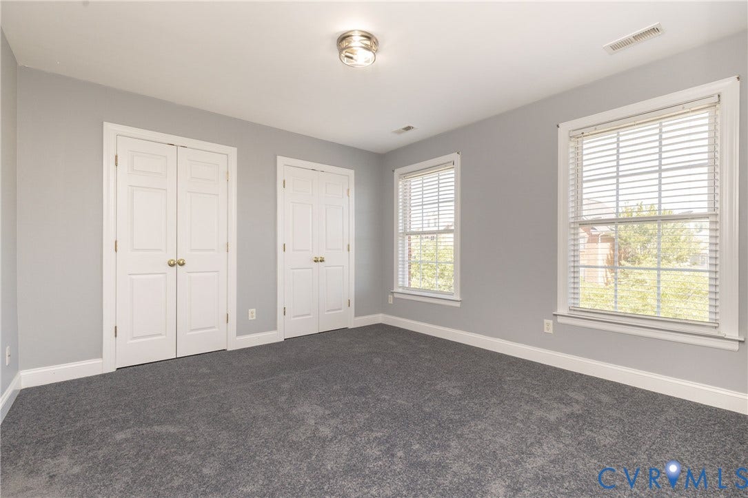 Room featuring light gray walls, gray carpeting, and white trim