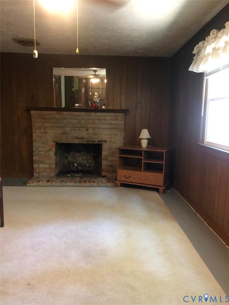 10001 Alfaree Road, Kendale Acres Addition, Chester, VA 23237 Brick fireplace with a dark wood mantel and wood-paneled walls
