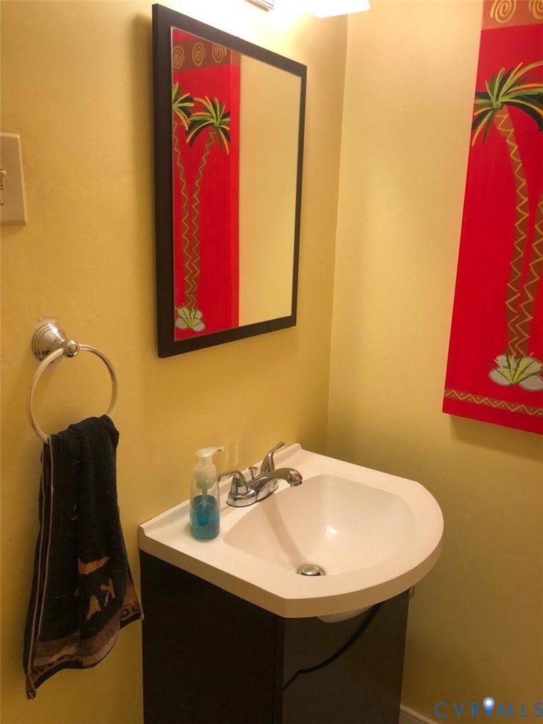 10001 Alfaree Road, Kendale Acres Addition, Chester, VA 23237 Wall-mounted vanity with a white basin and chrome faucet