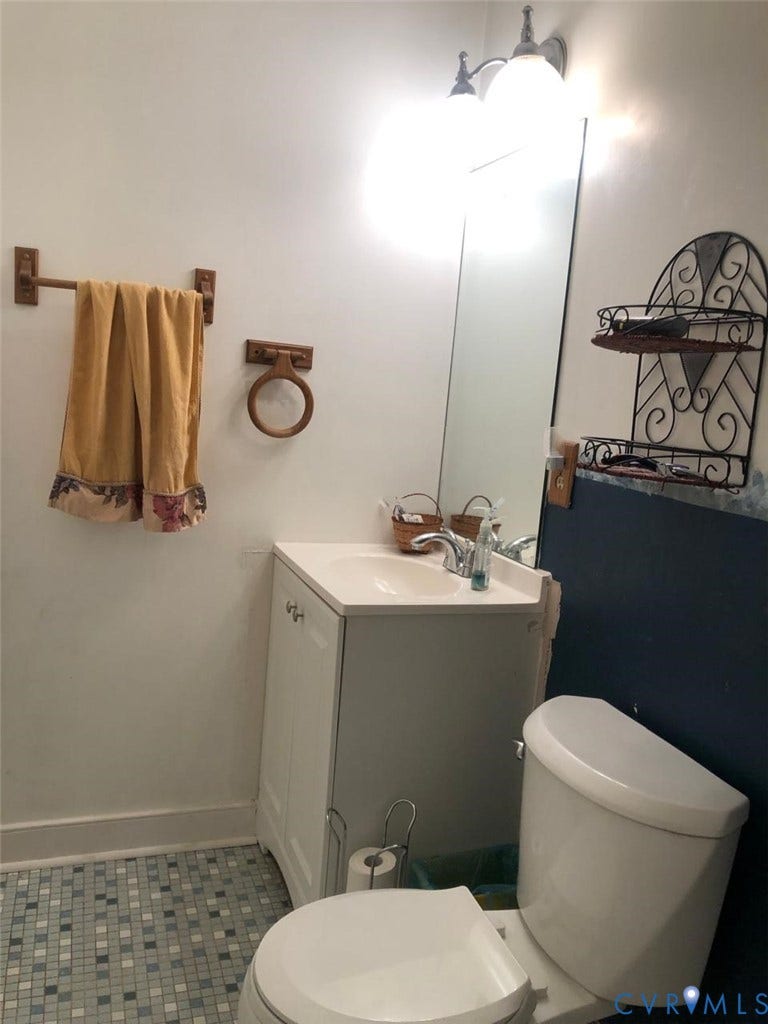 10001 Alfaree Road, Kendale Acres Addition, Chester, VA 23237 White vanity with integrated sink, mosaic tile flooring, and wall-mounted light fixture