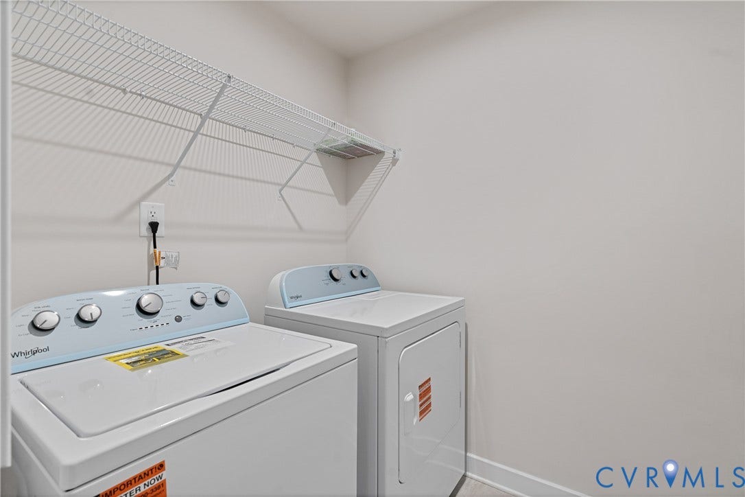 7213 Lyon Taylor Lane, Summer Maple, New Kent, VA 23124 Dedicated laundry area featuring a white wire storage shelf, light-toned wall paint, and baseboard trim