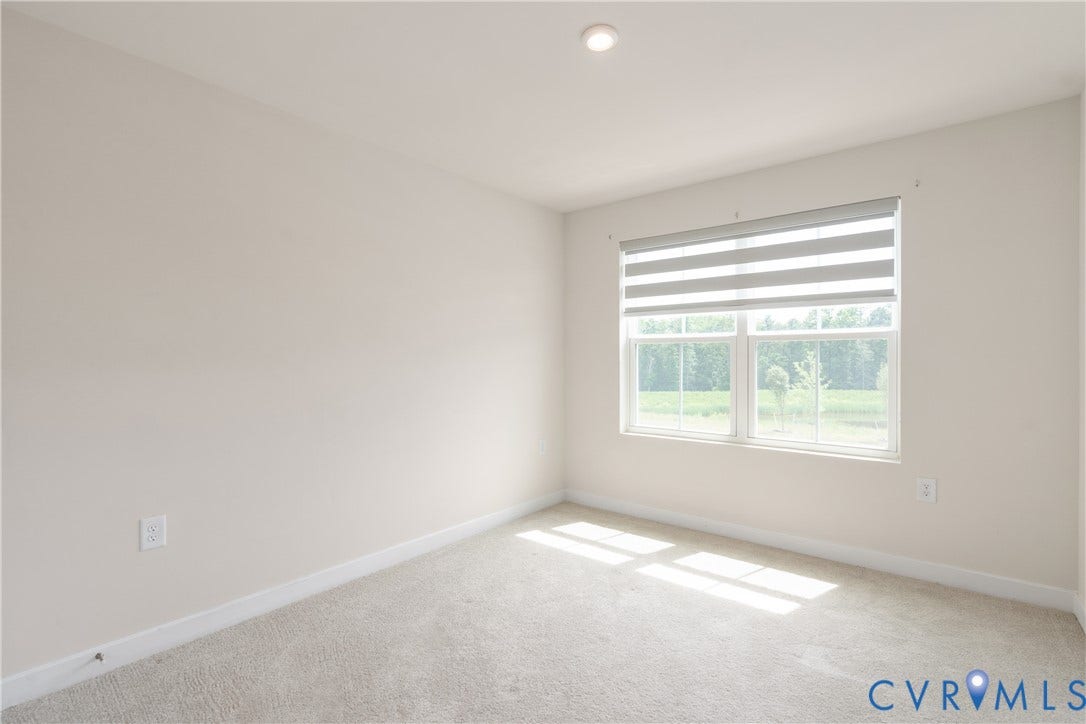 7213 Lyon Taylor Lane, Summer Maple, New Kent, VA 23124 Neutral-toned room featuring a window with integrated blinds, recessed lighting, and light-colored carpeting
