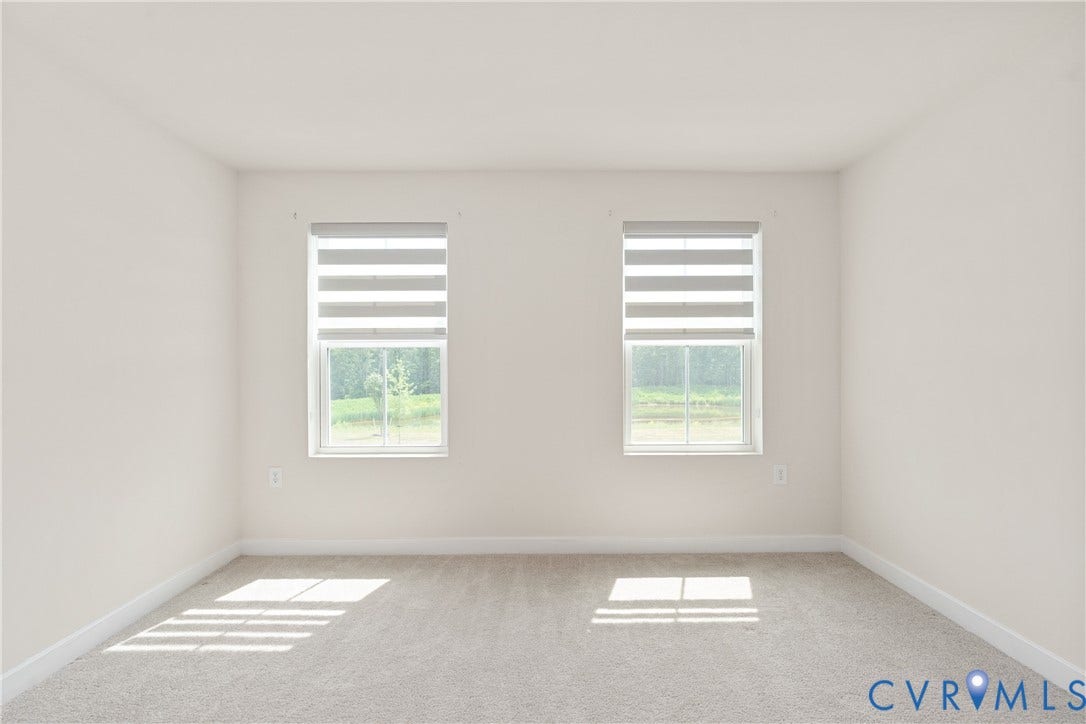 7213 Lyon Taylor Lane, Summer Maple, New Kent, VA 23124 Spacious room featuring neutral paint, two windows with horizontal blinds, light-toned carpeting, and white baseboards