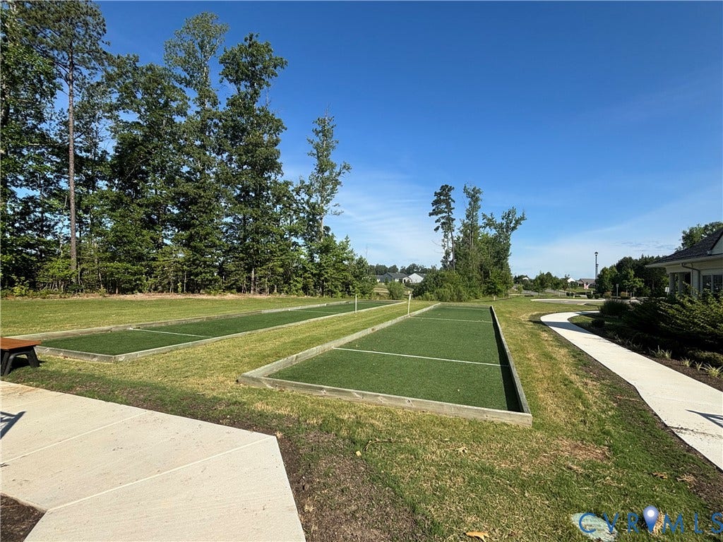 7213 Lyon Taylor Lane, Summer Maple, New Kent, VA 23124 Two artificial turf bocce ball courts with surrounding grassy areas and a concrete pathway