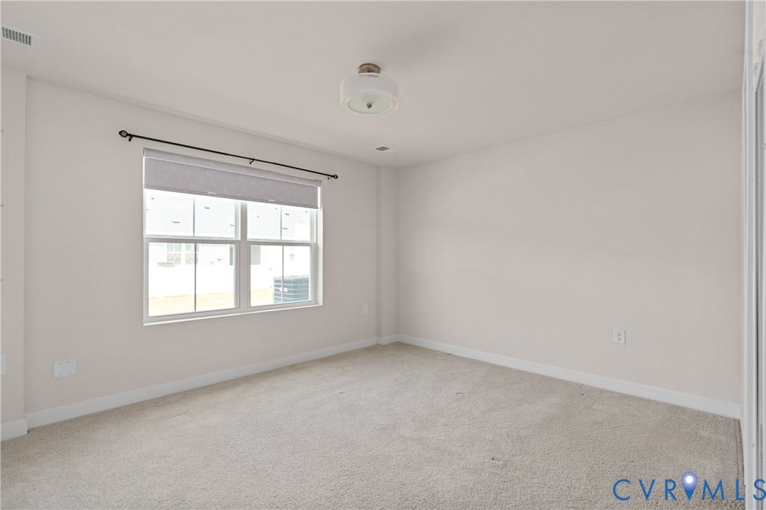 7213 Lyon Taylor Lane, Summer Maple, New Kent, VA 23124 Carpeted room featuring a double window with roller shade, neutral wall paint, and white trim