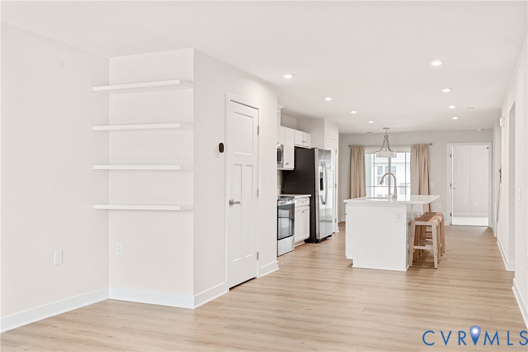 7213 Lyon Taylor Lane, Summer Maple, New Kent, VA 23124 Open-concept living space featuring wood-finish flooring, recessed lighting, and built-in shelving