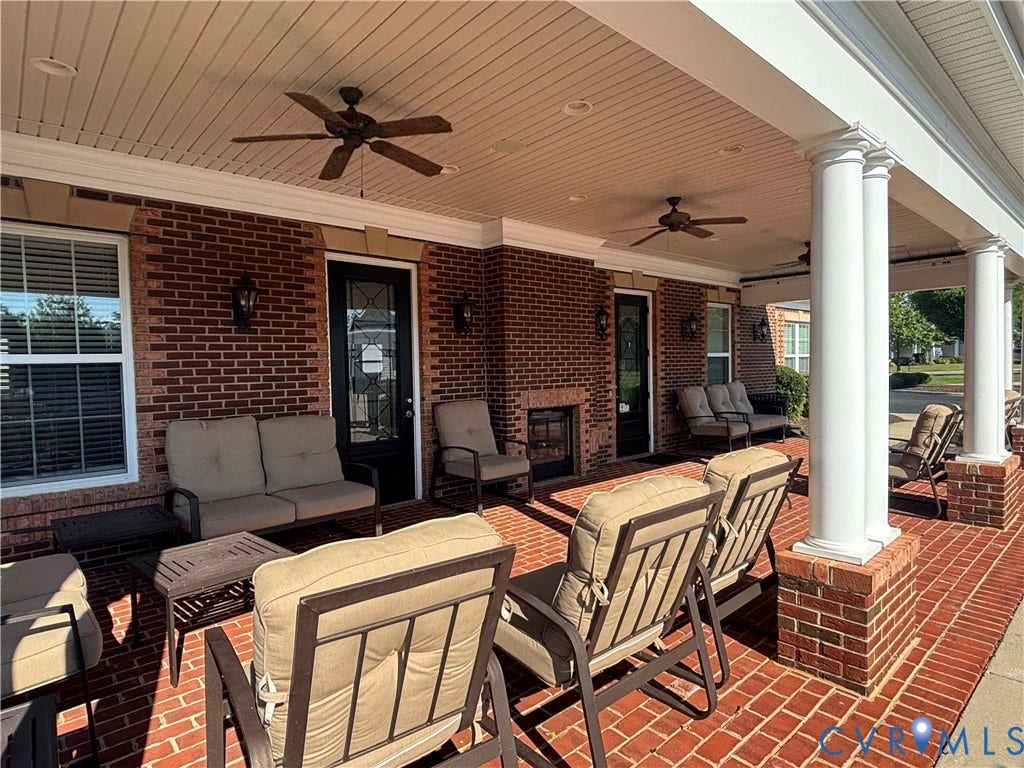 7213 Lyon Taylor Lane, Summer Maple, New Kent, VA 23124 Expansive brick-paved covered patio featuring white architectural columns, a brick exterior, multiple ceiling fans, and recessed lighting