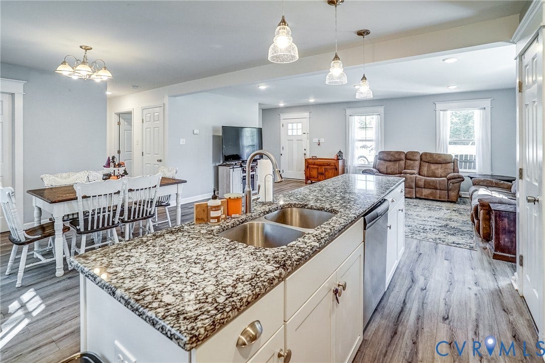 65 Hopeful Church Lane, Bumpass, VA 23024 Dining area featuring wood-finish flooring, a multi-pane window with white trim, a built-in refrigerator, and a ceiling-mounted light fixture