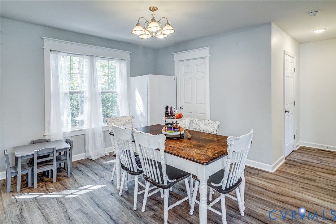 65 Hopeful Church Lane, Bumpass, VA 23024 Open-concept kitchen and dining area featuring wood-finish flooring, white cabinetry, recessed lighting, and pendant lights