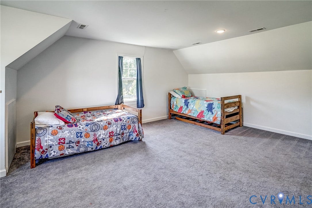 65 Hopeful Church Lane, Bumpass, VA 23024 Carpeted room featuring a double-pane window with interior trim, white walls, and a white six-panel door