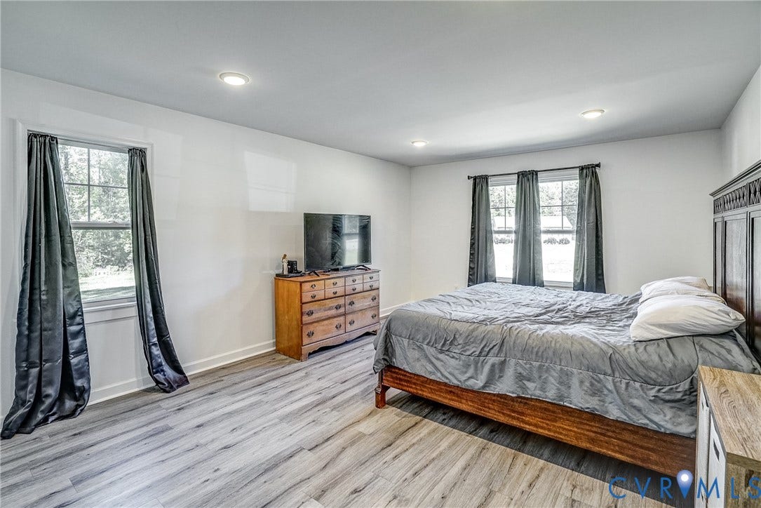 65 Hopeful Church Lane, Bumpass, VA 23024 Spacious room featuring light wood-finish flooring, recessed lighting, white painted walls, white baseboards, and white paneled doors