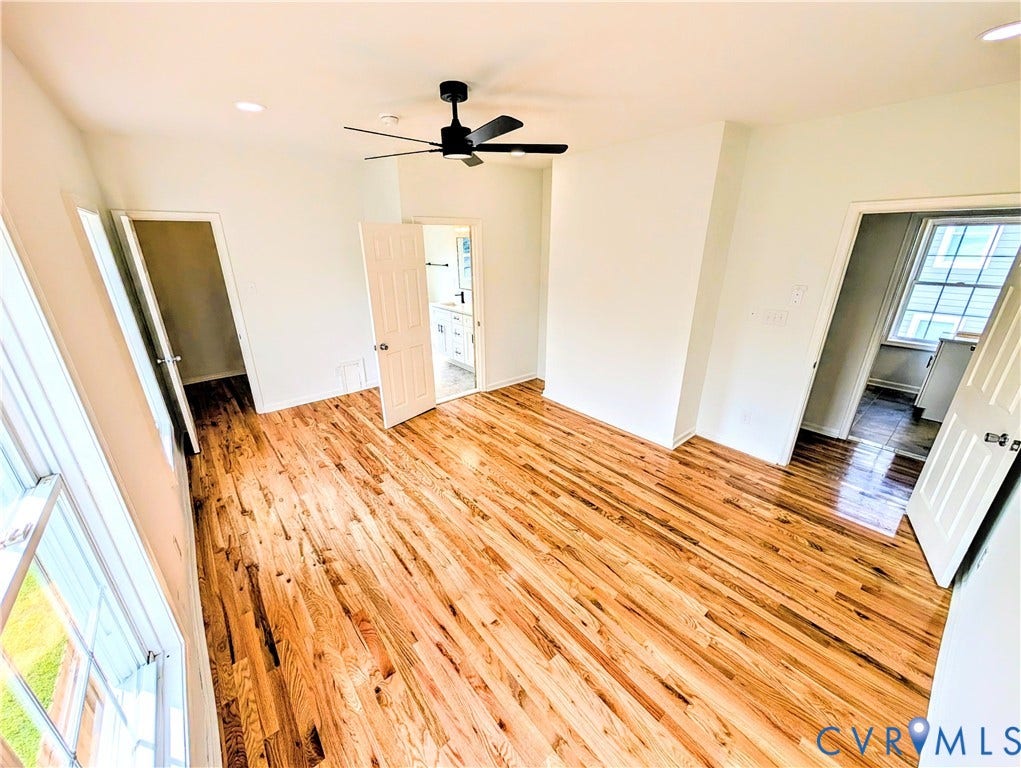 3216 Enslow Avenue, Richmond, VA 23222 Spacious room featuring wood-finish flooring, white walls, and a contemporary ceiling fan