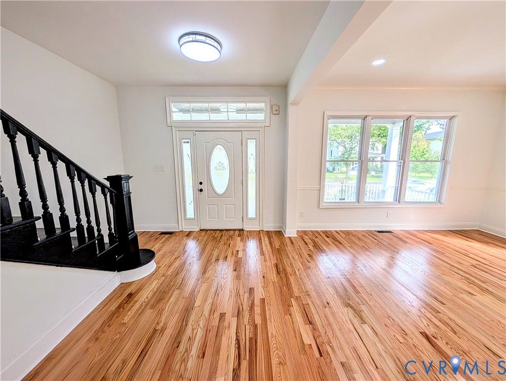 3216 Enslow Avenue, Richmond, VA 23222 Hardwood flooring extends throughout this entry and main living area, complemented by a white paneled entry door with decorative glass inserts and sidelights