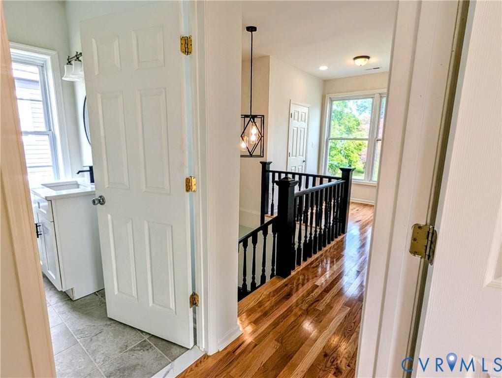 3216 Enslow Avenue, Richmond, VA 23222 Upper-level hallway with wood-finish flooring and black spindle railing