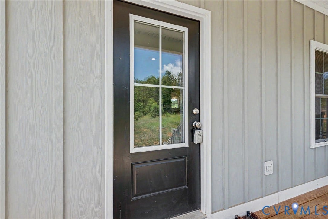 815 Kennon Road, Northeast Creek Reservoir Subd, Mineral, VA 23117 Black exterior door with window panes and white trim